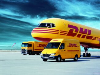 DHL cargo aircraft with DHL delivery van and truck on an airport tarmac
