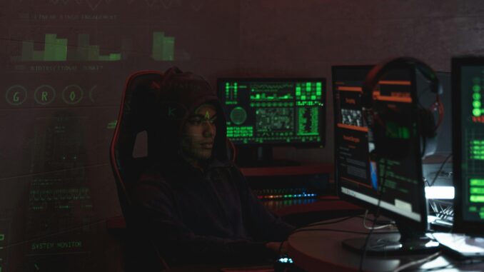 Cybersecurity analyst monitoring security dashboards on multiple screens