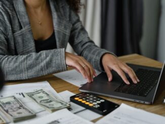 Accounts and admin assistant working on Pastel and processing client orders in an office