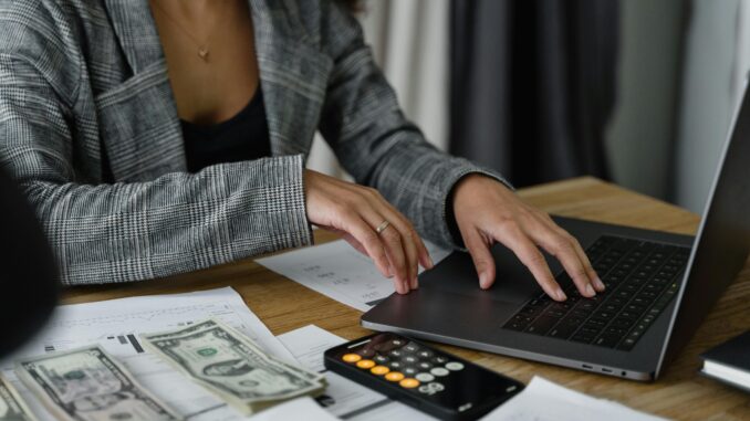 Accounts and admin assistant working on Pastel and processing client orders in an office