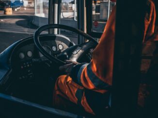 Driver trainer standing next to a truck at a training centre