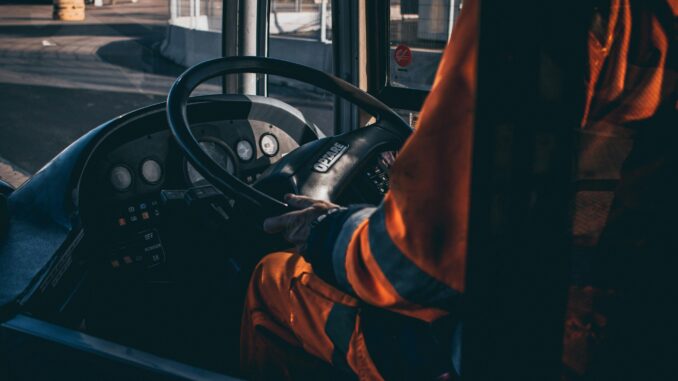 Driver trainer standing next to a truck at a training centre