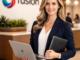 Professional administrator standing in a modern office with a laptop and folder, representing the company “fusion” logo in the background.