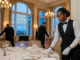 Hotel staff setting a fine dining table inside a luxury restaurant at The Capital Hotel