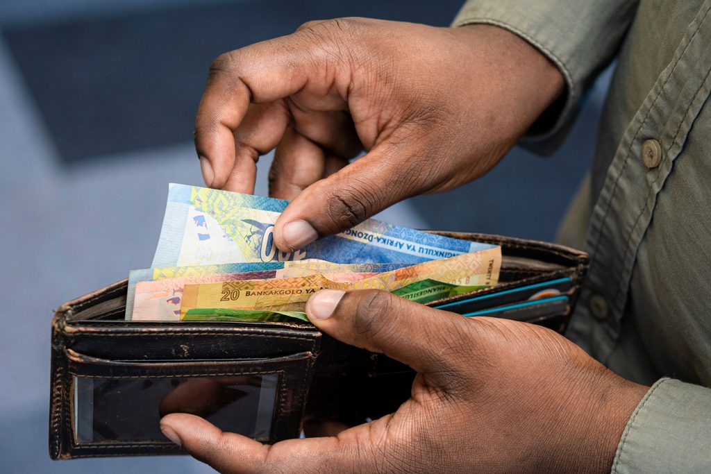 Person budgeting and managing personal finances in South Africa